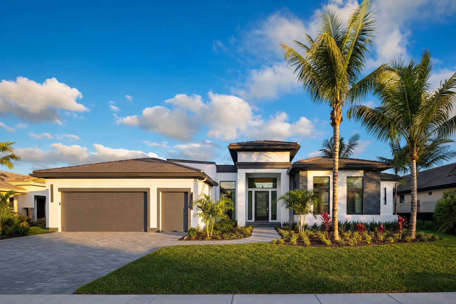 Golden hour front elevation of a modern white stucco family home in Pembroke Pines